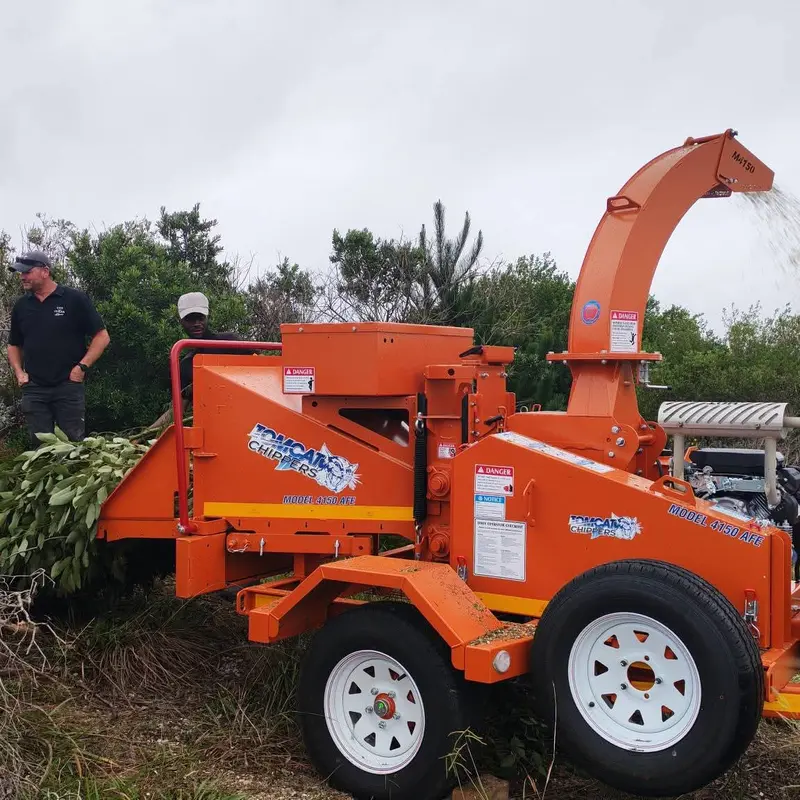 Wood chipper processing branches on site